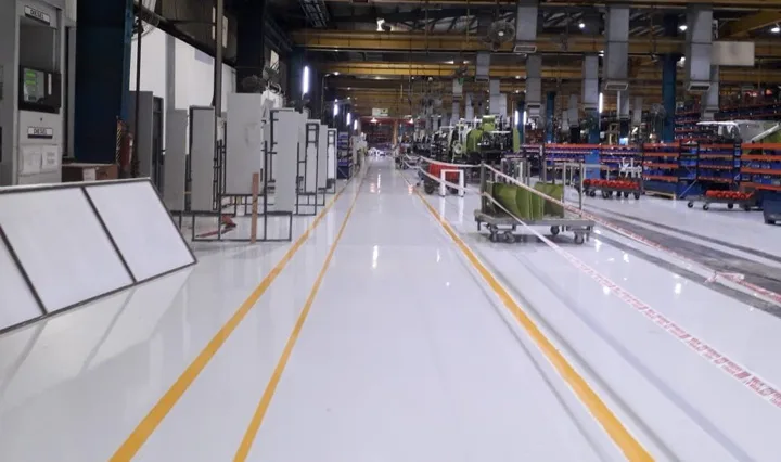 Industrial epoxy flooring with yellow aisle markings, from the JP Flooring website